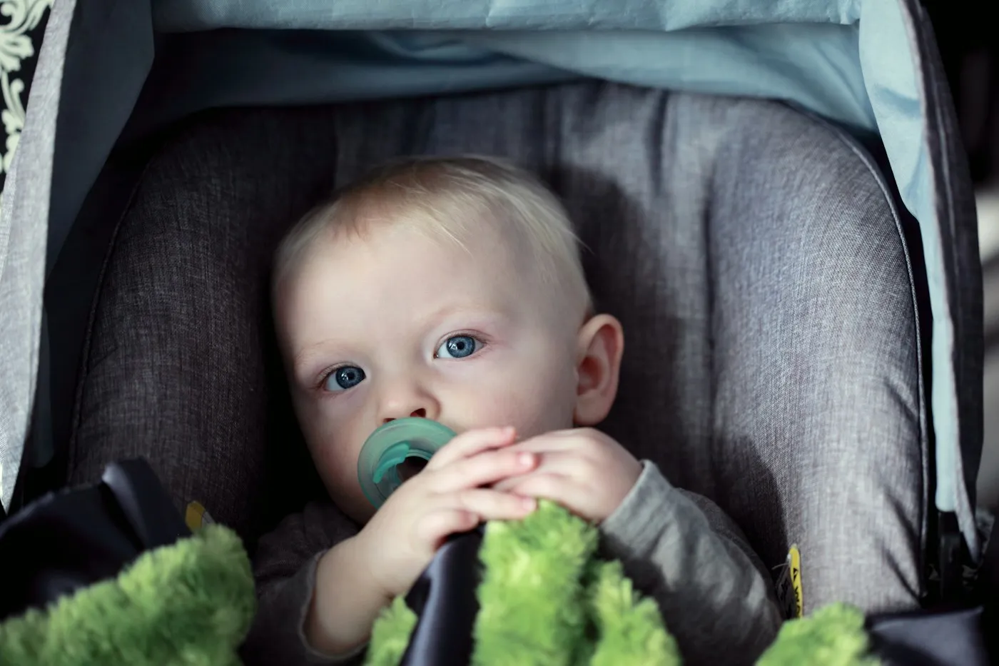 A baby safely buckled in a car seat