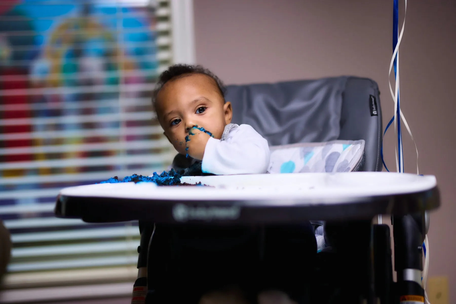A baby eating in a high chair