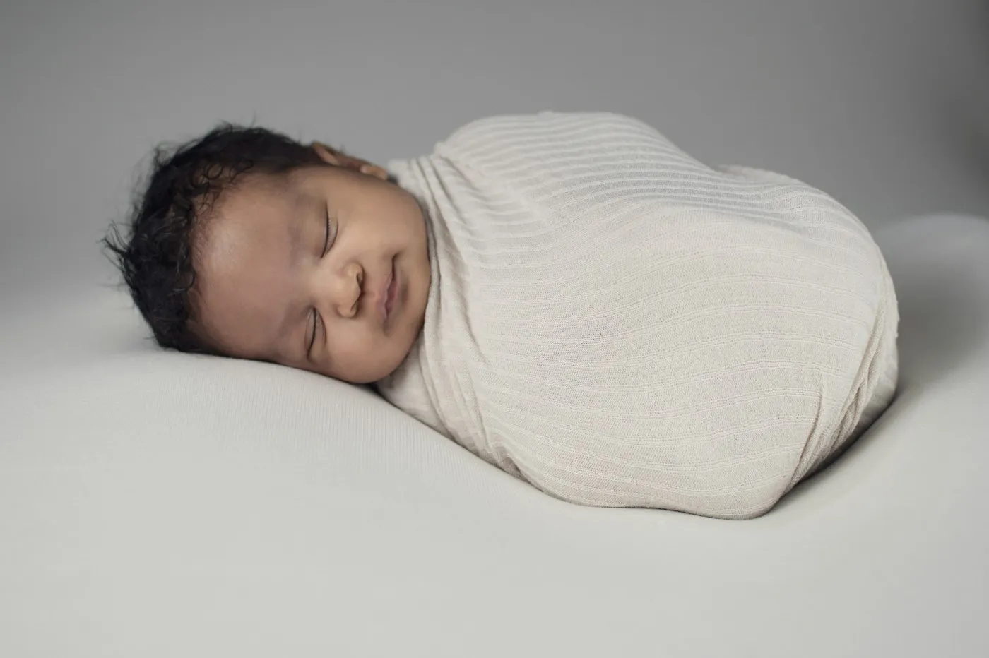 A swaddled newborn sleeping
