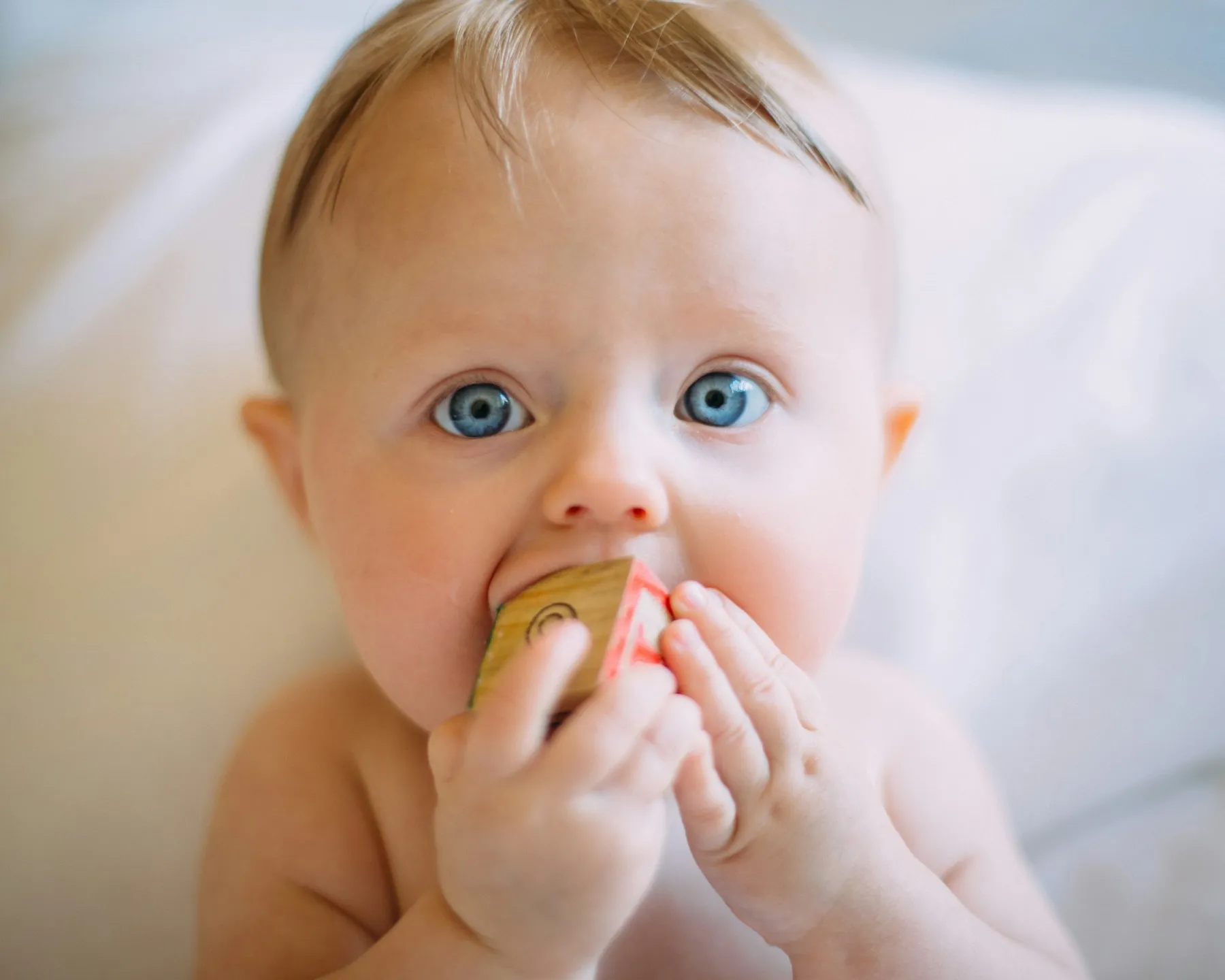 A baby chewing on a teether